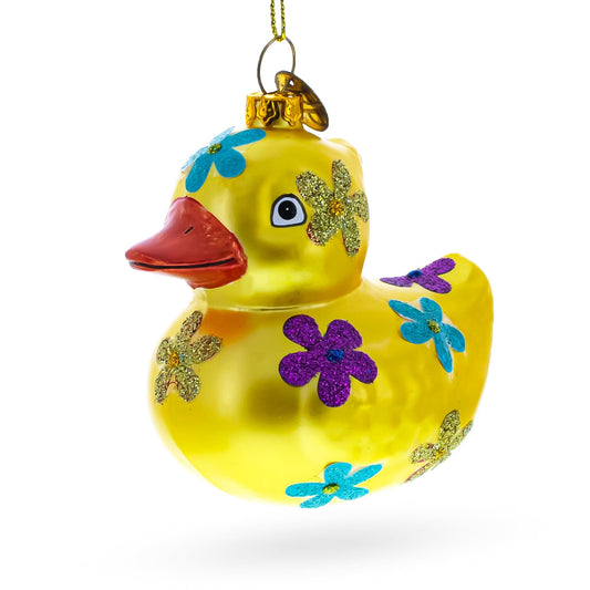 a yellow duck ornament with flowers