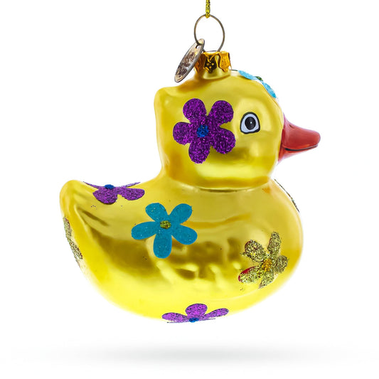 a yellow duck with flowers on it