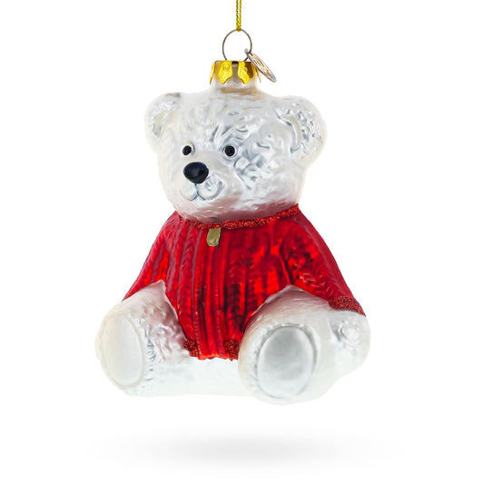 a white bear with a red sweater from a gold string