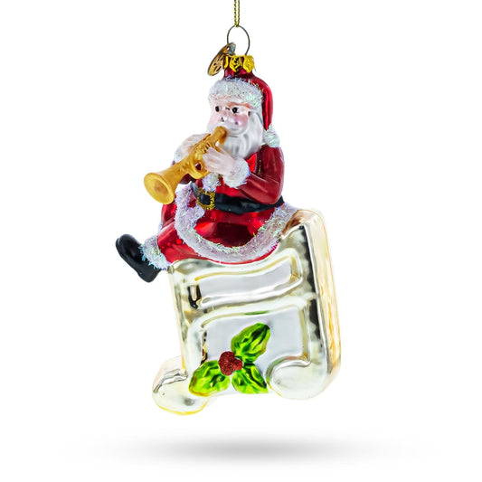 a christmas ornament with santa claus playing a trumpet