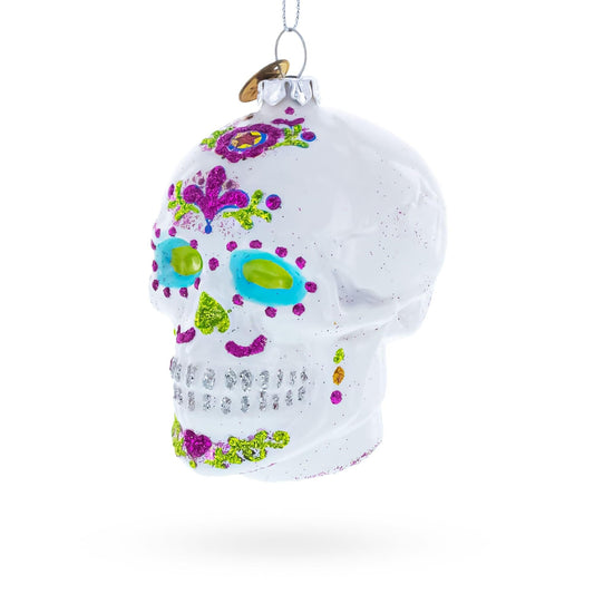 a white skull ornament with colorful glitter