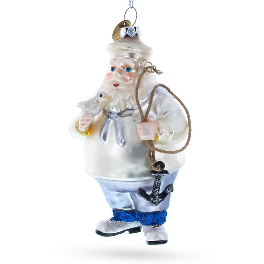 a christmas ornament with a sailor holding a rope and a bird