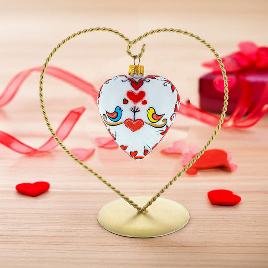 a heart shaped ornament in a gold frame
