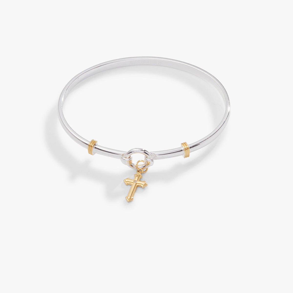 a silver bracelet with a gold cross charm