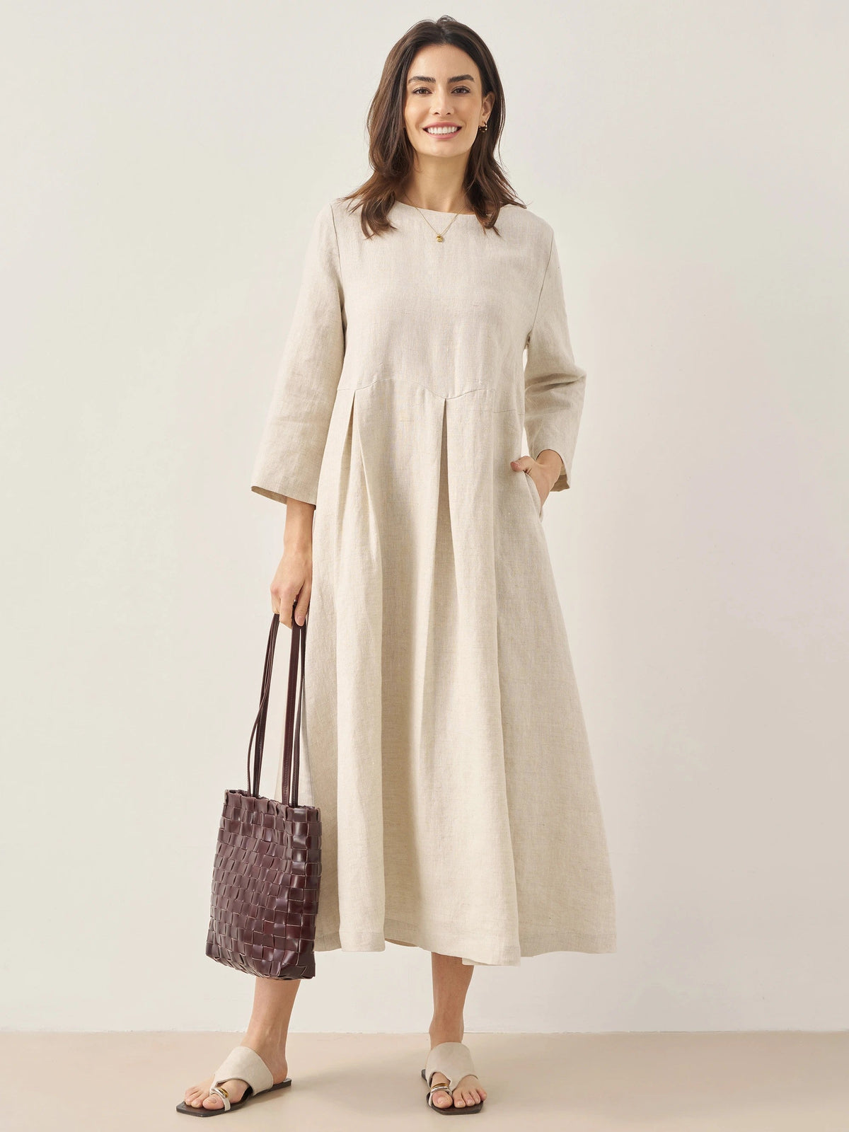 a woman in a white dress holding a purse