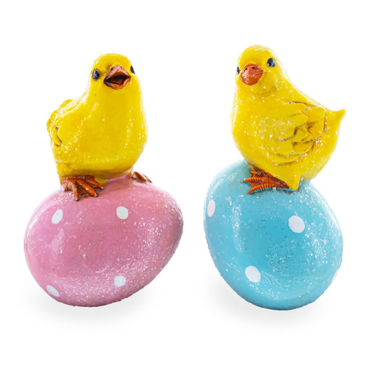 two yellow chicks on a pink and blue egg