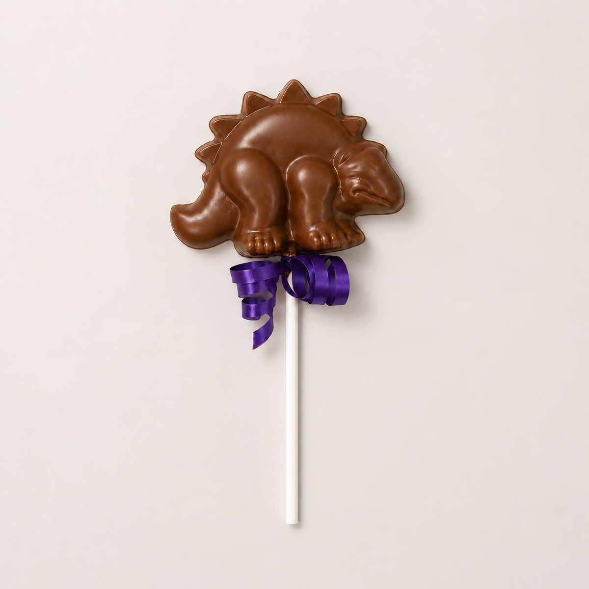 a chocolate dinosaur on a stick