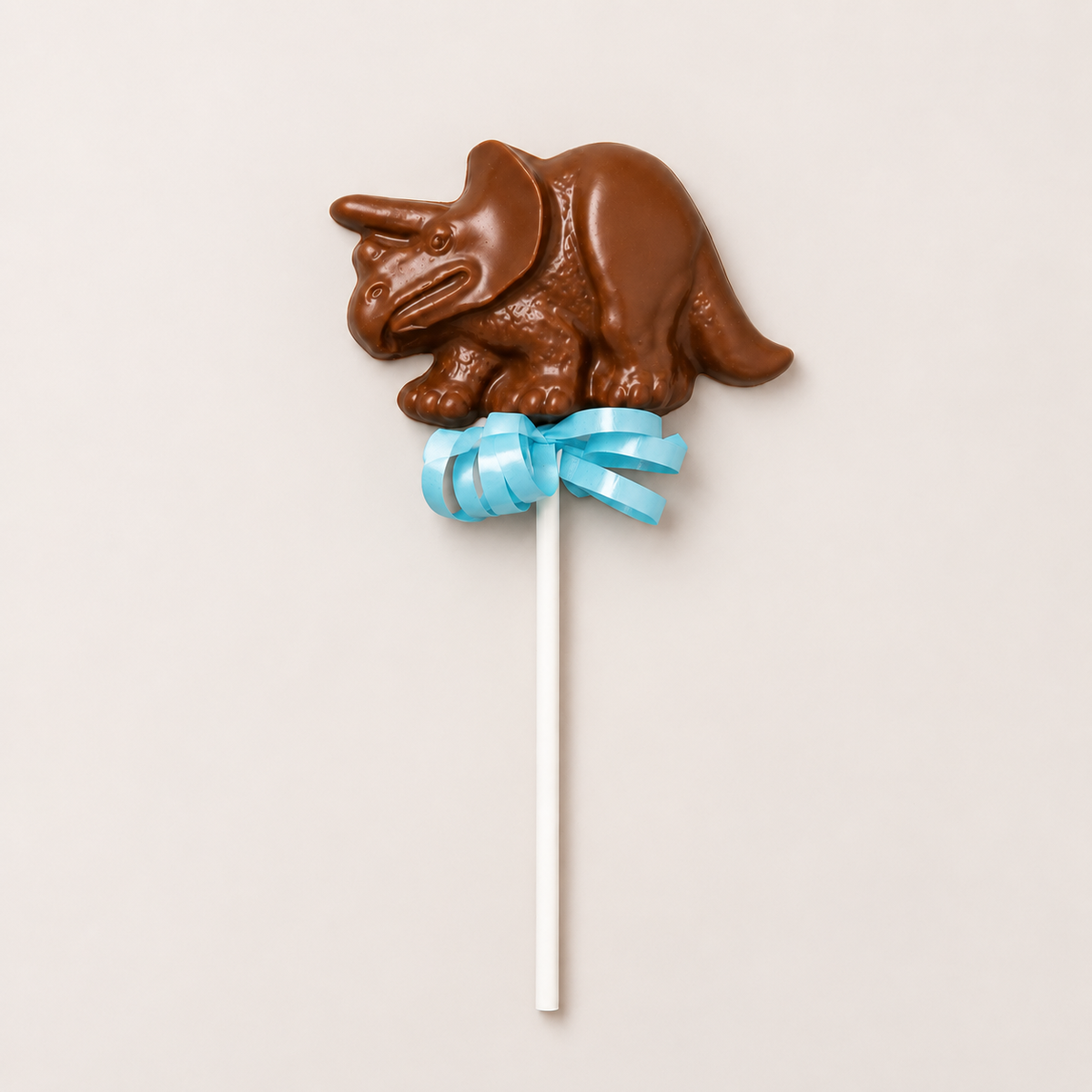 a chocolate dinosaur on a stick