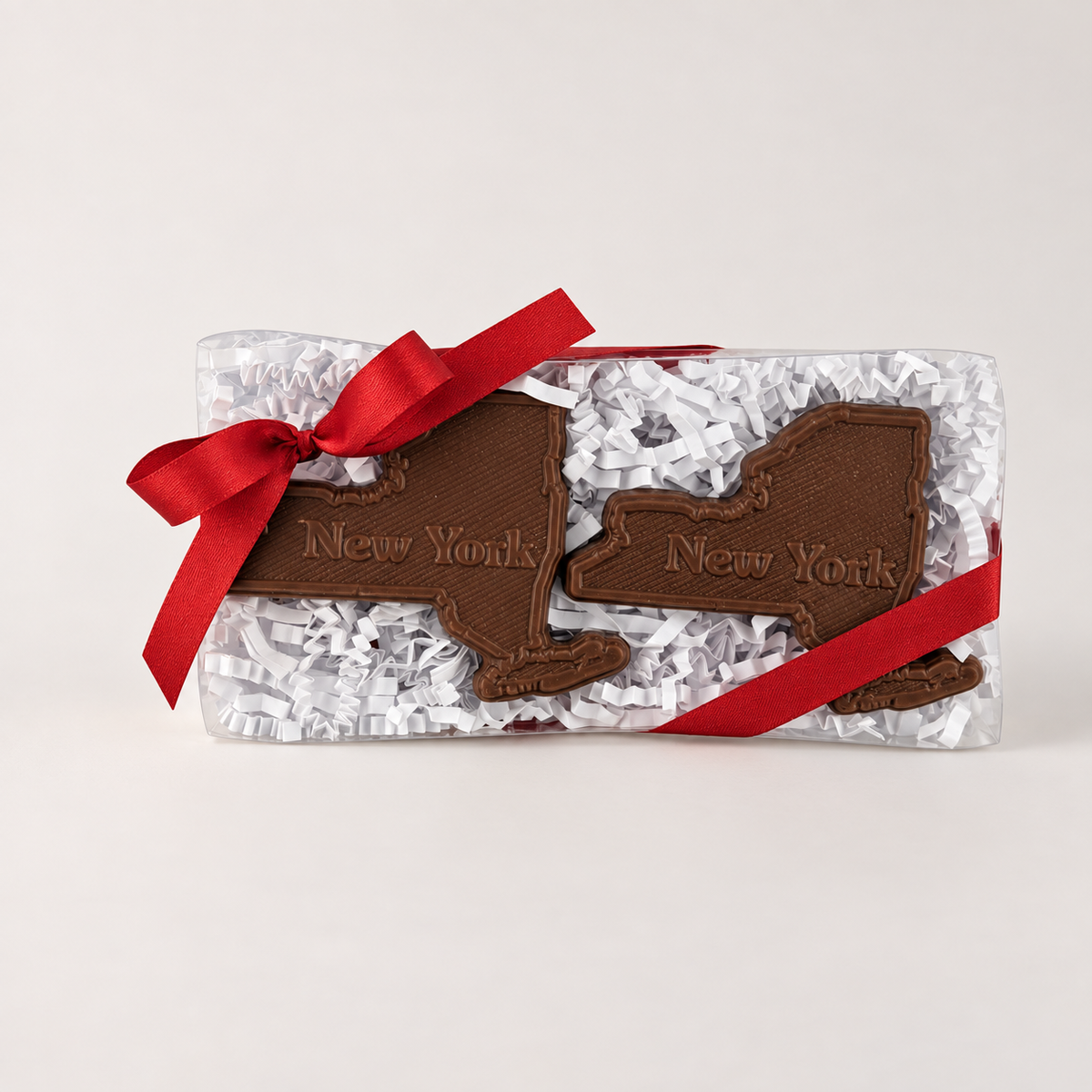 a chocolate shaped like state with a red ribbon
