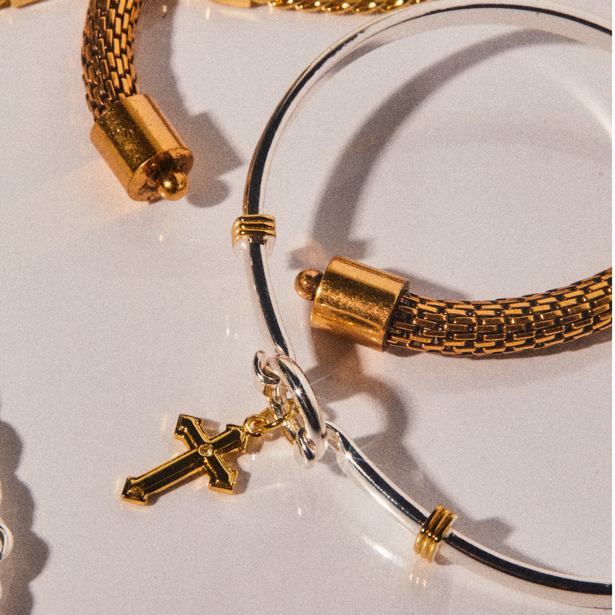 a group of gold and silver bracelets