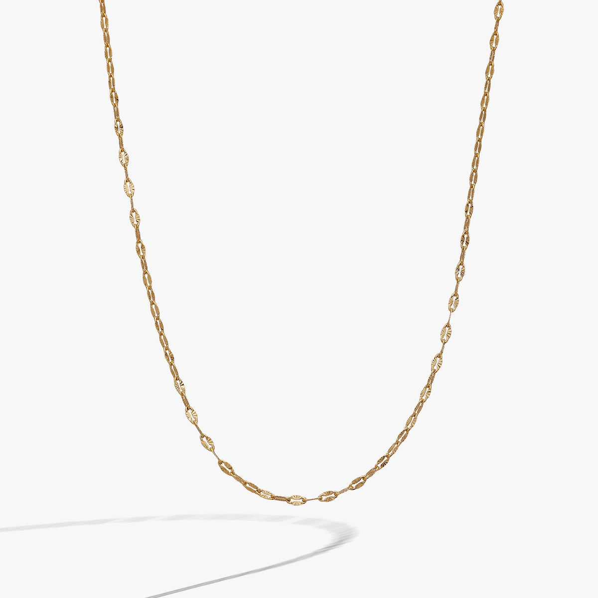 a gold chain on a white background