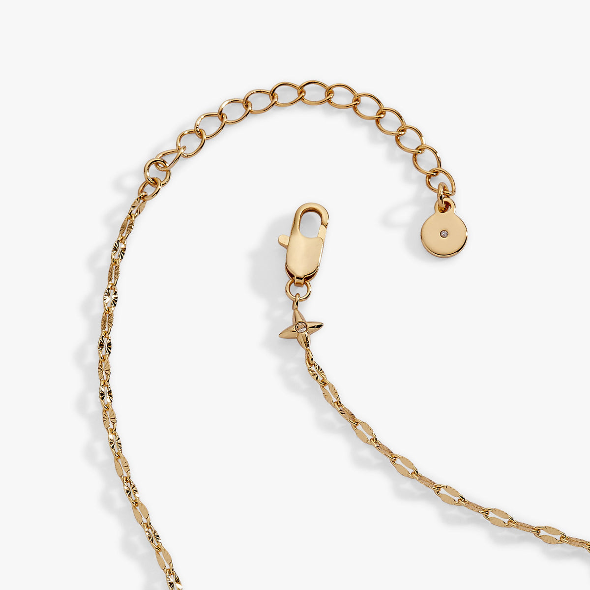 a gold chain with a star and a hole