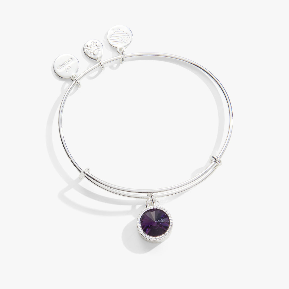 a silver bracelet with a purple stone