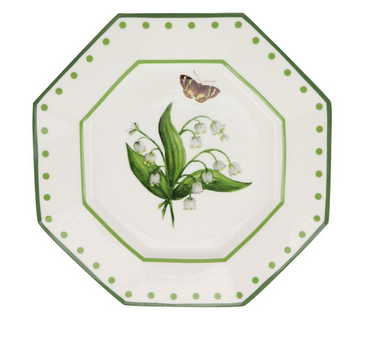 a plate with a butterfly and lily of the valley