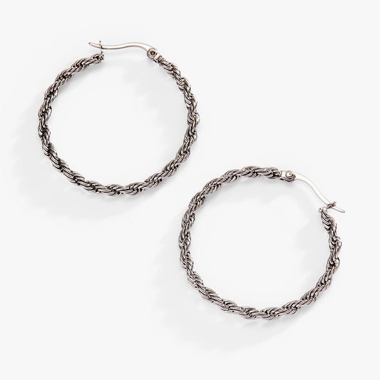 a pair of earrings on a white background