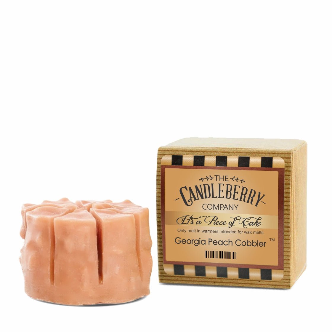 a peach colored candle in a box