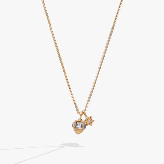 a gold necklace with a small stone and a star