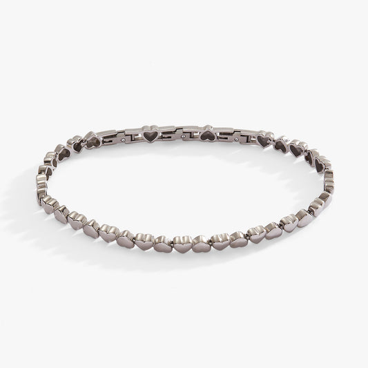 a silver bracelet with hearts on it