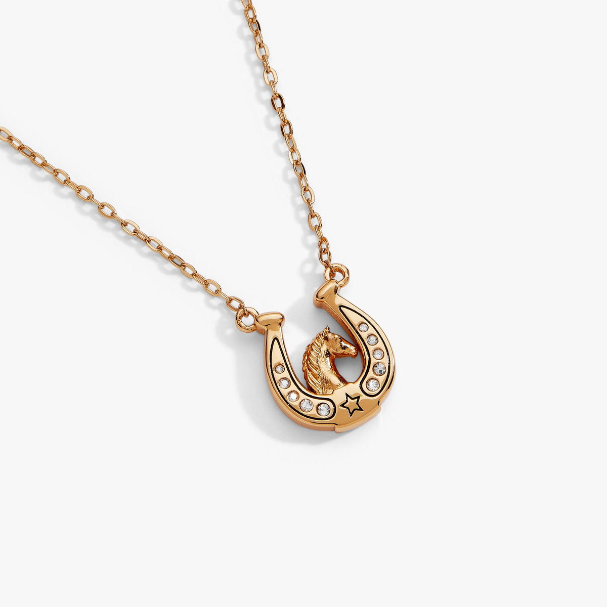 a gold horseshoe necklace with diamonds