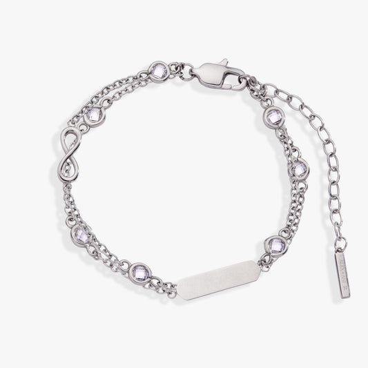 a silver bracelet with a silver bar and diamonds