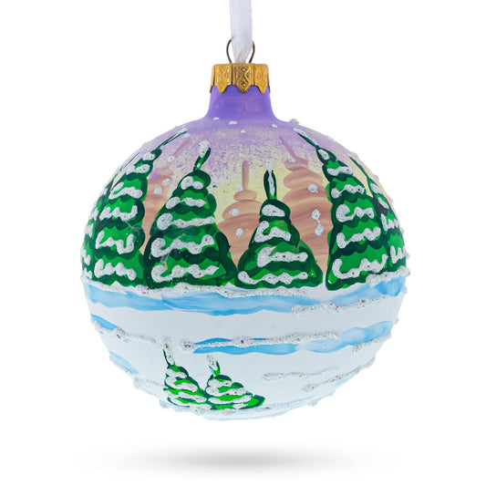 a christmas ornament with trees painted on it