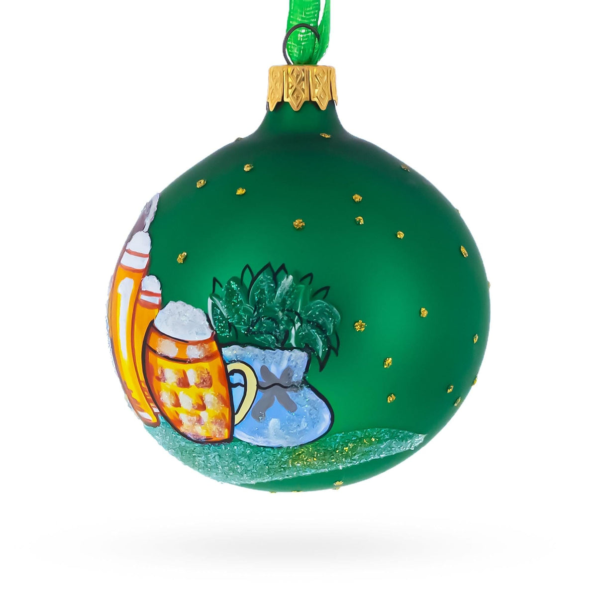 a green christmas ornament with a painting on it