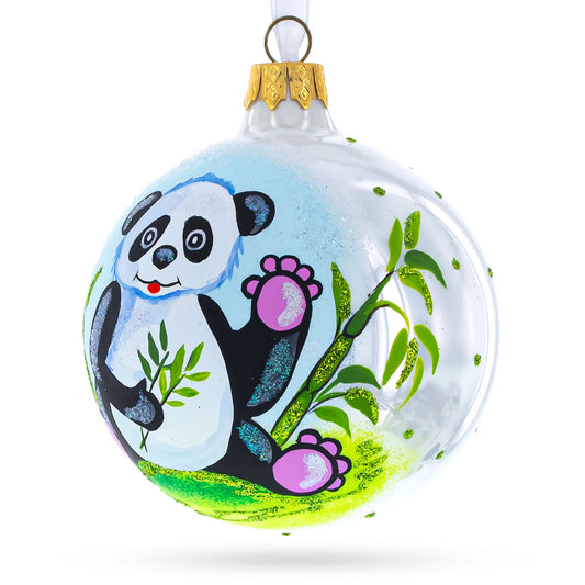 a white and green ornament with a panda painted on it