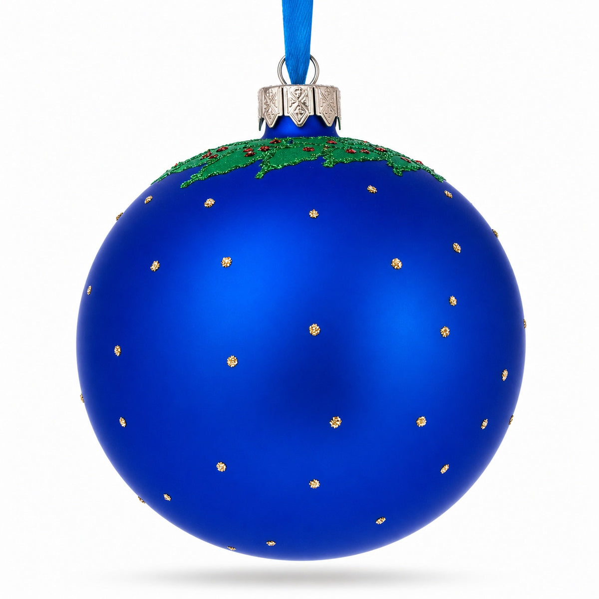 a blue christmas ornament with green and gold dots