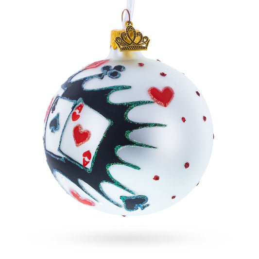 a white and black ornament with a gold crown and playing cards