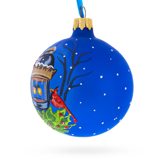 a blue christmas ornament with a bird on it