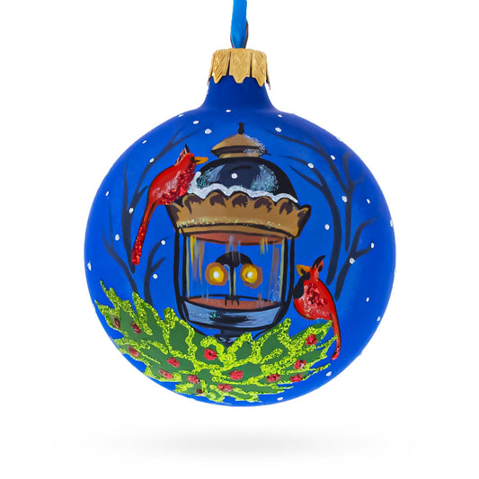 a blue christmas ornament with a bird and a bird on it