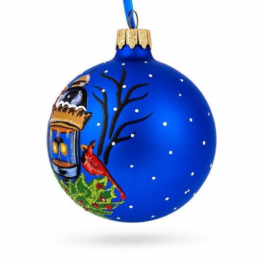 a blue christmas ornament with a bird and a lantern