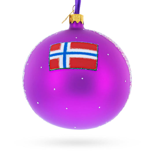 a purple christmas ornament with a flag