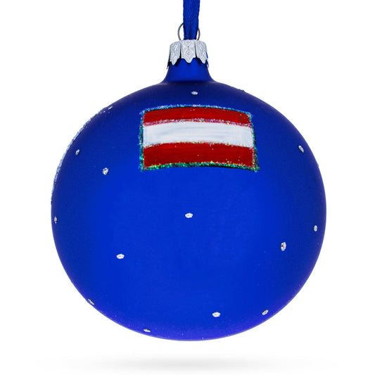 a blue christmas ornament with a red and white flag