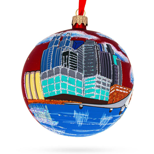 a red ball with a painting of a city on it
