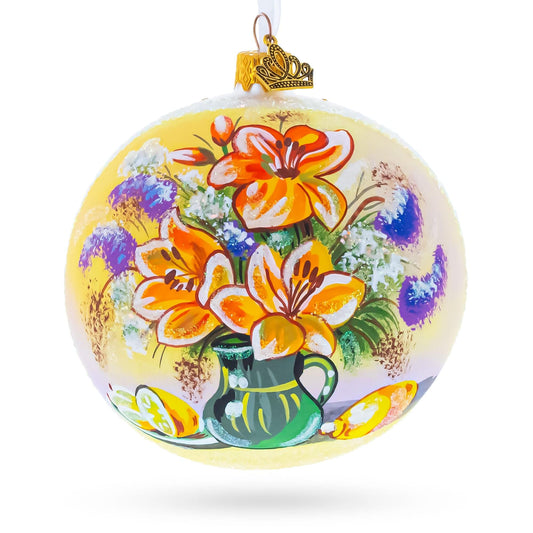 a yellow and orange ornament with flowers painted on it