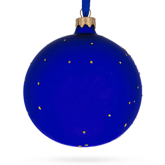 a blue christmas ornament with gold dots