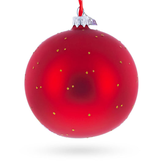 a red christmas ornament with gold dots