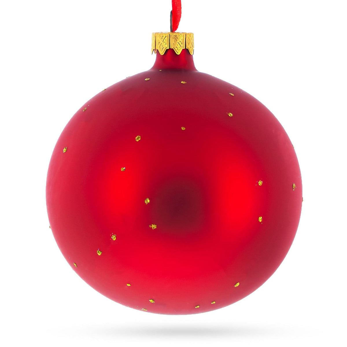 a red christmas ornament with gold dots