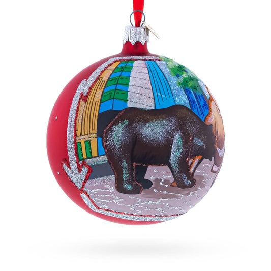 a red and white christmas ornament with a bear painted on it
