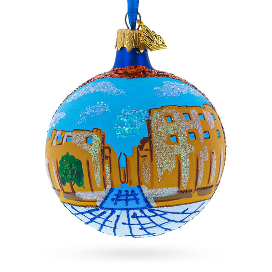 a blue and gold ornament with a picture of a city