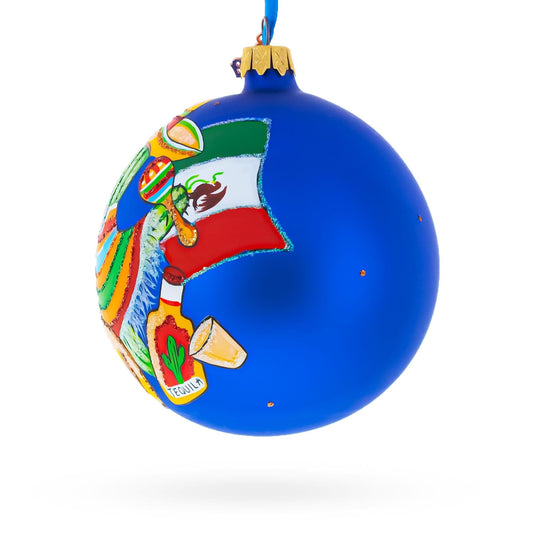 a blue christmas ornament with a painting on it
