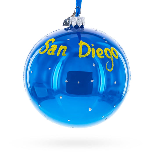 a blue christmas ornament with a name on it