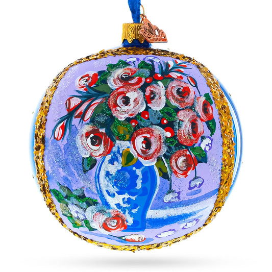 a blue and gold ornament with a vase of flowers painted on it