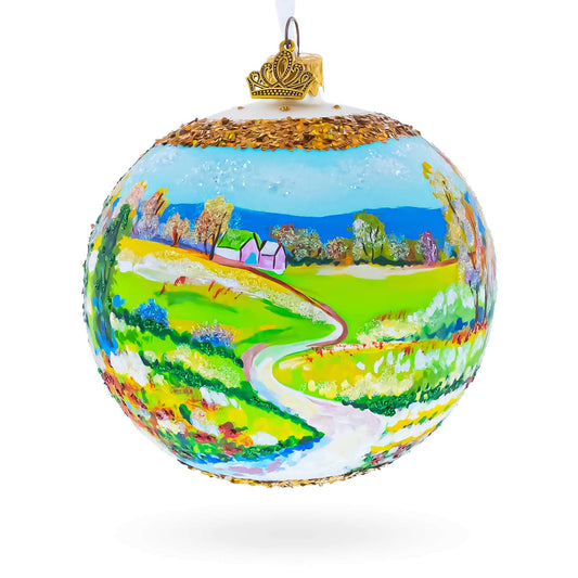 a christmas ornament with a painting of a landscape