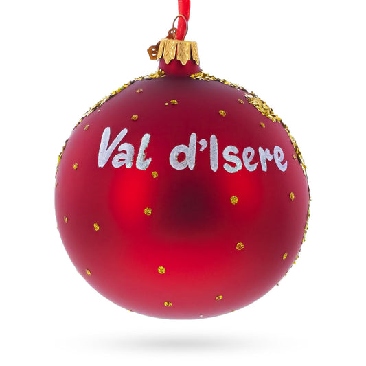 a red christmas ornament with gold dots and white text