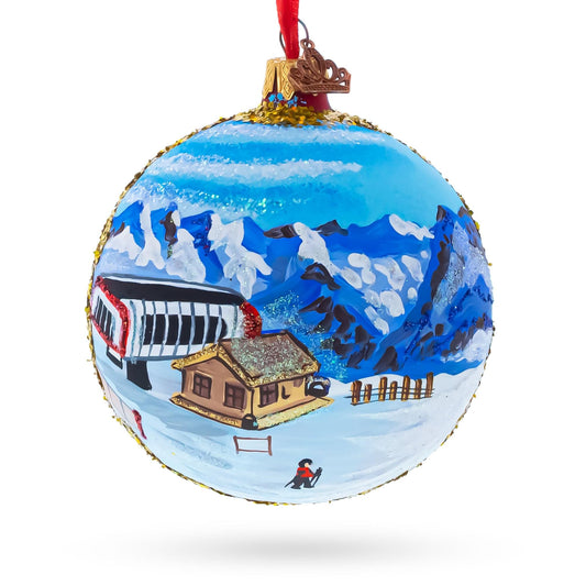 a christmas ornament with a painting of a mountain landscape