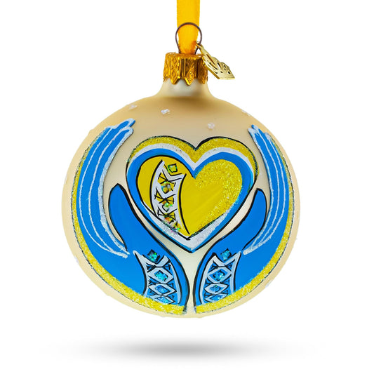 a christmas ornament with a heart and hands painted on it