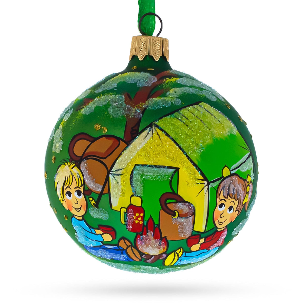 a green christmas ornament with a painting on it
