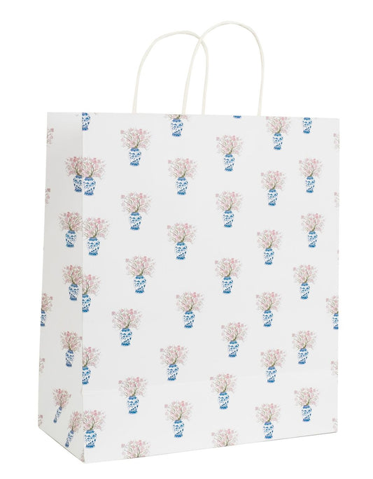 a white bag with a vase of flowers on it